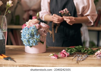 happy professional woman is working in flower shop  - Powered by Shutterstock