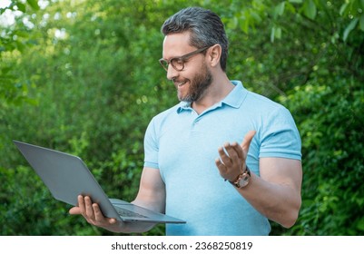 happy programmer man working online on laptop. photo of programmer man online on computer. - Shutterstock ID 2368250819