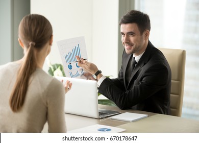Happy project manager holds financial report, shows rising stats and growing graphs to colleague, satisfied with great development rate, successful strategy, business growth, company success concept 