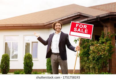 Happy Property Manager Holding FOR SALE Sign Near Residential Building Outside