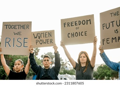 Happy protesters with placards on street - Shutterstock ID 2311807605