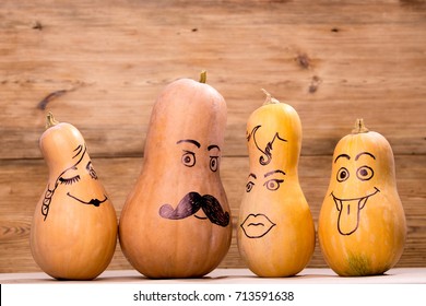 Happy Pumpkin Family Funny Faces Isolated Over Rustic Wooden Background