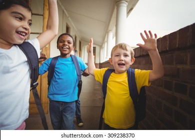 Happy Pupils Leaving The Classroom In School