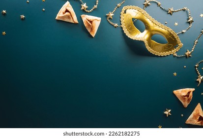 Happy Purim carnival decoration concept made from golden mask star and glitter on dark background. (Happy Purim in Hebrew, jewish holiday celebrate) - Shutterstock ID 2262182275