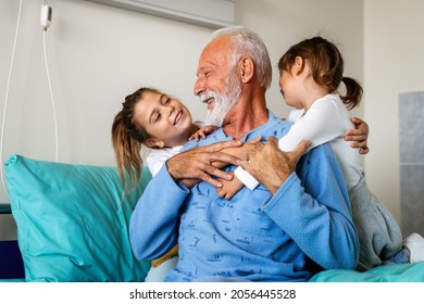Happy recovering grandfather is visited by his grandchildren in the hospital.