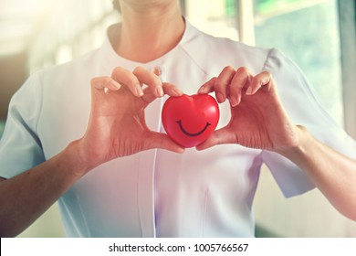 Happy Red Smiling Face Heart in Nurses Hands. Good Health Support and Protection Business Hospital Private Service Concept. - Powered by Shutterstock