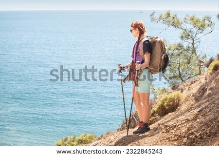 Similar – Image, Stock Photo Redheaded hiker with water bottle on nature getaway