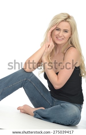 Happy Relaxed Attractive Young Woman in Her Twenties Sitting on the Floor Looking at the Camera