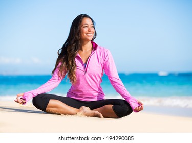 Happy relaxed young woman practicing yoga outdoors at the beach. Healthy natural lifestyle.