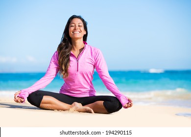 Happy relaxed young woman practicing yoga outdoors at the beach. Healthy natural lifestyle.