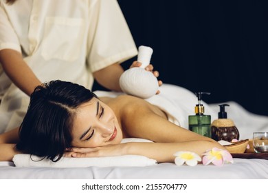 Happy relaxing asian girl at beauty spa treatment. Beauty young asian woman recieving massage at spa, massager's hands on the woman's shoulder spa concept. Young woman with Glow, and perfect Skin. - Powered by Shutterstock