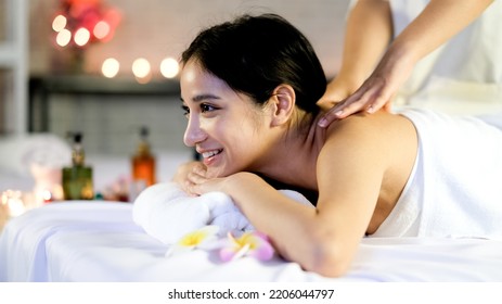 Happy relaxing asian girl at beauty spa treatment. Beauty young asian woman recieving massage at spa, massager's hands on the woman's shoulder spa concept. Young woman with Glow, and perfect Skin. - Shutterstock ID 2206044797