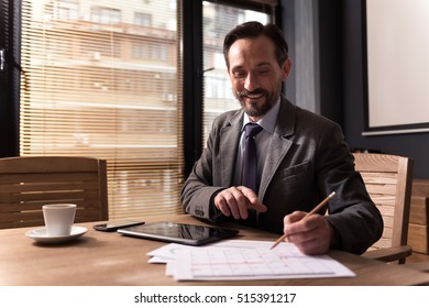 Happy Responsible Man Looking At The Calendar