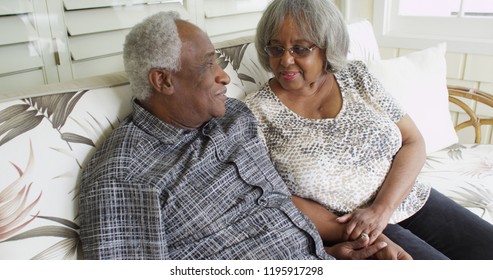 Happy Retired Black Couple Sitting On A Couch