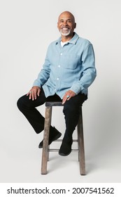 Happy retired man sitting on a stool