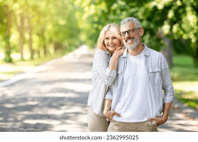 Happy Retirement. Romantic Senior Couple Relaxing Together In Sunny Park, Cheerful Mature Man And Woman Embracing And Looking Away, Smiling Older Spouses Enjoying Spending Time Outdoors, Copy Space - Powered by Shutterstock