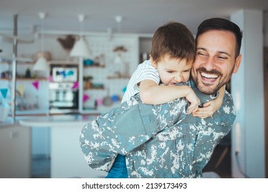 Happy reunion of one young soldier with family, five years old son and father having fun in the house during the beautiful sunny day. Soldier dad hugs his son after a time in military. - Powered by Shutterstock