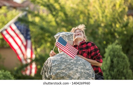 Happy Reunion Of Soldier With Family Outdoors. Father With His Son Hugging, Holiday, Homecoming, Emotions, Happiness