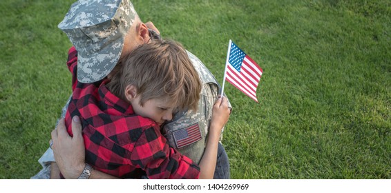 Happy Reunion Of Soldier With Family Outdoors. Father With His Son Hugging, Holiday, Homecoming, Emotions, Happiness