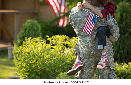 Happy Reunion Of Soldier With Family Outdoors. Father With His Son Hugging, Holiday, Homecoming, Emotions, Happiness