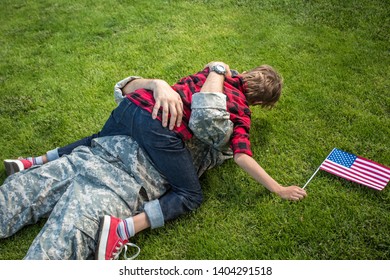 Happy Reunion Of Soldier With Family Outdoors. Father With His Son Hugging, Holiday, Homecoming, Emotions, Happiness