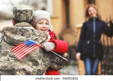 Happy reunion of soldier with family outdoors - Powered by Shutterstock