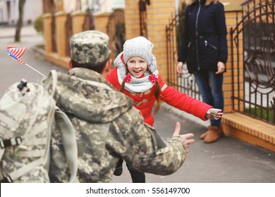 Happy reunion of soldier with family outdoors - Powered by Shutterstock