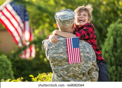 Happy Reunion Of Soldier With Family, Son Hug Father With American Flag