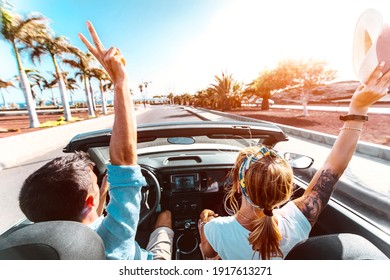 Happy romantic couple driving convertible car on the road - Newlywed on a romantic date	
