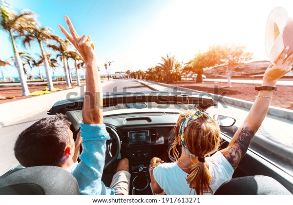 Happy romantic couple driving\
convertible car on the road - Newlywed on a romantic\
date	\
