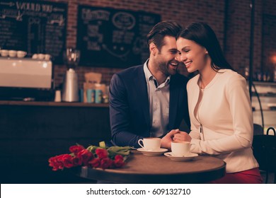 Happy romantic couple sitting in a cafe drinking coffee. - Powered by Shutterstock