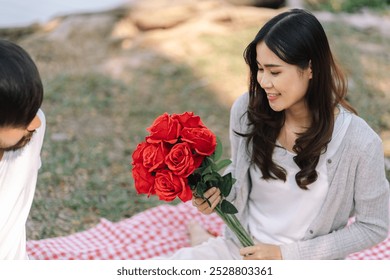 Happy romantic couple in Valentine's Day with red roses romantic date Picnic. - Powered by Shutterstock