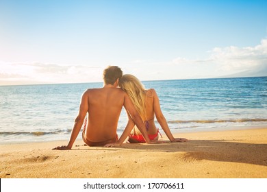 Happy Romantic Couple Watching The Sunset On Tropical Beach Vacation