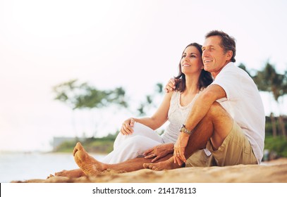 Happy Romantic Mature Couple Enjoying Sunset on the Beach