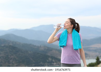 Happy Runner Drinking Water From Plastic Bottle After Sport In The Mountain