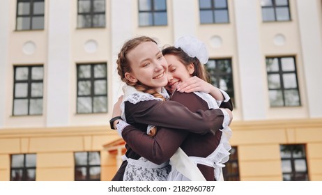 Happy Russian schoolgirls hug on their last school day. - Powered by Shutterstock