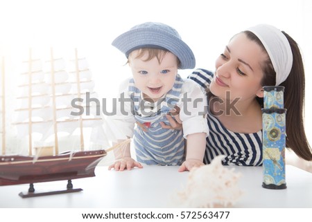 Happy sailor kid and mom playing indoors. Travel and adventure concept. Summer vacation