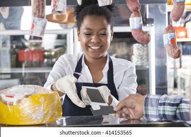 Happy Saleswoman Accepting Payment From Customer - Powered by Shutterstock