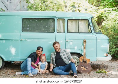 Happy Same-sex Family Resting Near Their Car Van. Adult Gay Couple With Little Daughter During Vacation.