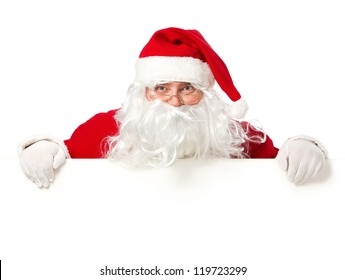 Happy Santa Claus looking out from behind the blank sign isolated on white background with copy space - Powered by Shutterstock