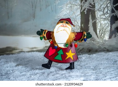 A happy santa dances in the snow with a string of christmas lights - Powered by Shutterstock