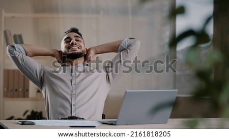Similar – Image, Stock Photo Hispanic guy leaning on hand sitting against colorful illumination with opened mouth