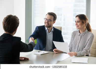 Happy Satisfied Hr Manager Handshaking Hiring Successful Male Job Candidate, Smiling Employer Company Executive Shaking Hand Welcoming Greeting Seeker Making Good First Impression, Employment Concept