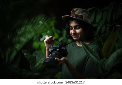 Happy and satisfied photographer, Asian girl photographer with professional camera, Young tourist lady looking at camera pictures - Powered by Shutterstock