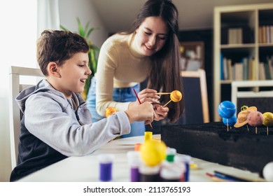 Happy School Boy And Girl  Making A Solar System For A School Science Project At Home