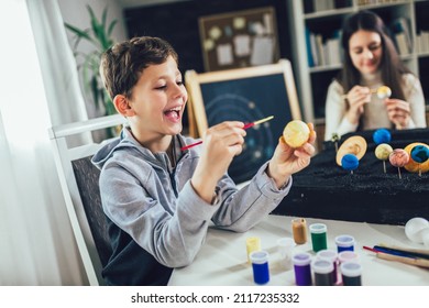 Happy School Boy And Girl  Making A Solar System For A School Science Project At Home