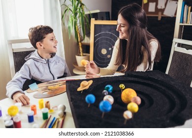 Happy School Boy And Girl  Making A Solar System For A School Science Project At Home