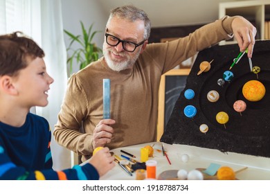 Happy School Boy And His Father Making A Solar System For A School Science Project At Home