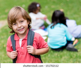 Happy School Boy Holding His Bag And Smiling 