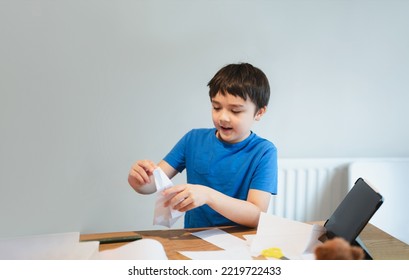 Happy School Boy Learn How To Making Origami Swan Paper. Kid Learning Paper Art Origami Lesson, Child Having Fun Doing Art And Craft At Home, Home Schooling,Back To School Concept